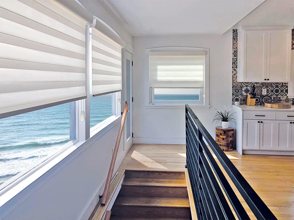 Beach house with custom roller shades and ocean views through large windows